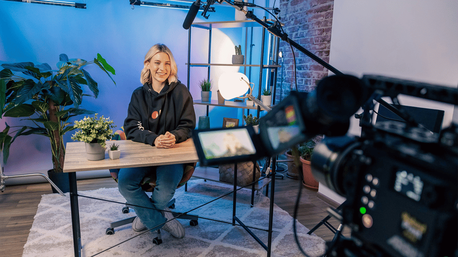  A content creator records a video of herself for her YouTube explainer videos. She will add the best royalty free background music for explainer videos.