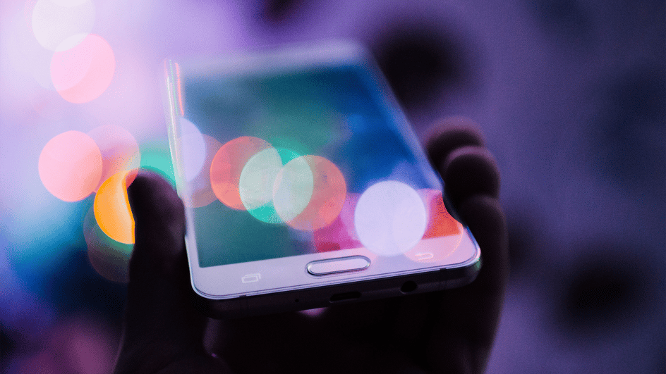  A hand holds a mobile phone in a video, with an android notification sound effect used to augment the sound.