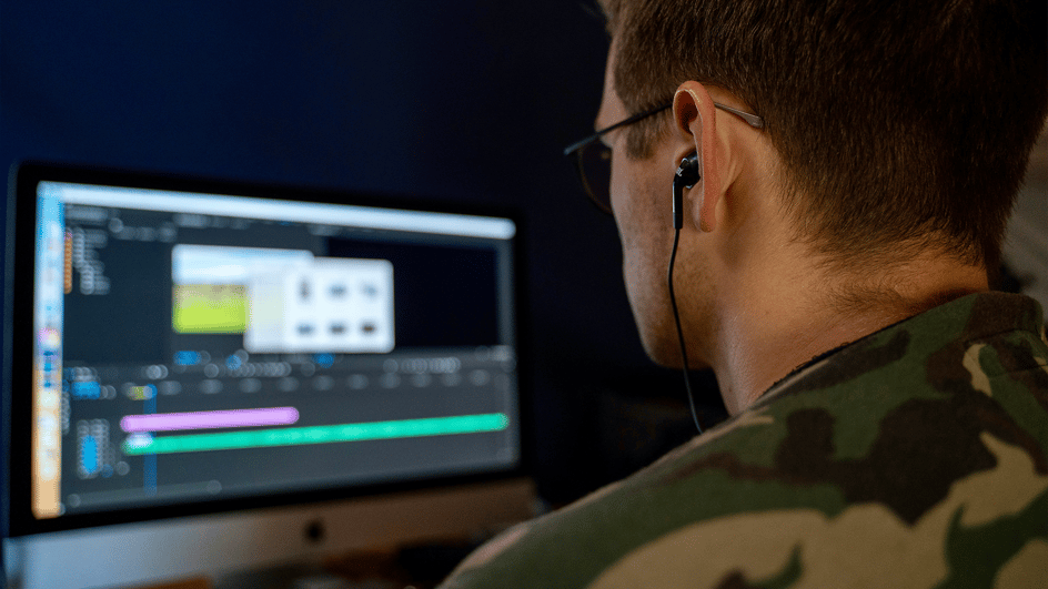  A content creator is looking at a computer screen, editing his video with the best audio plugin Premiere Pro has available