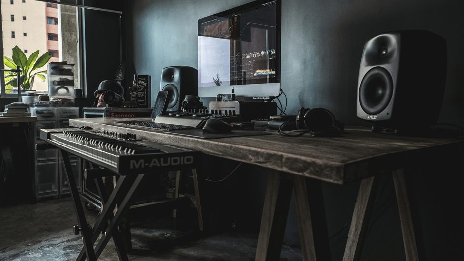  A beautiful edit suite is set up on a farmhouse-style table, using royalty free music for DaVinci Resolve to create its movie soundtracks.