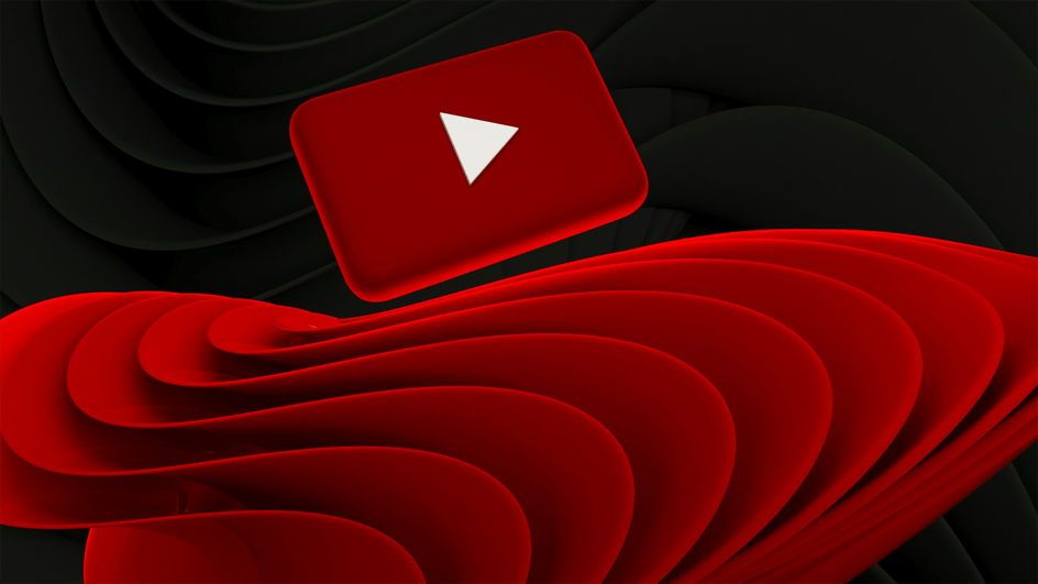  A red and white YouTube logo is suspended on a black background over a red design, loading a video which answers the question, “How much does YouTube pay for 1 million views?”