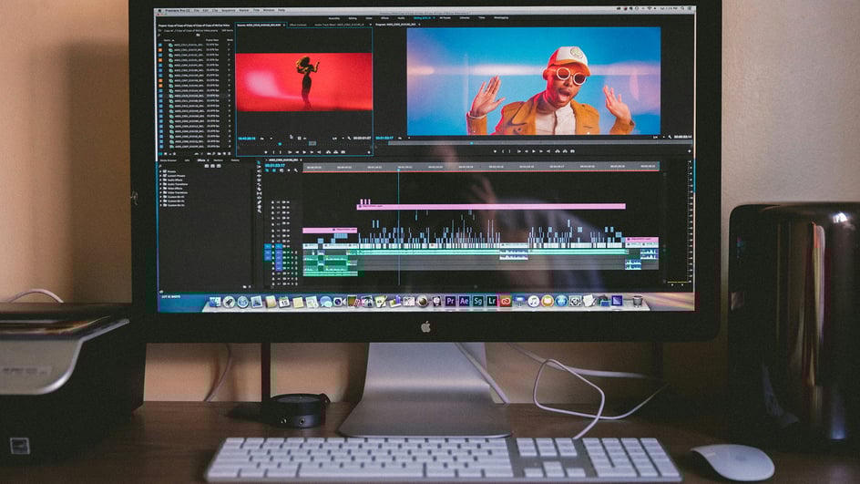  A desktop computer sits on a desk with a video editing software open, creating a video about ‘How to Edit Music in YouTube’.