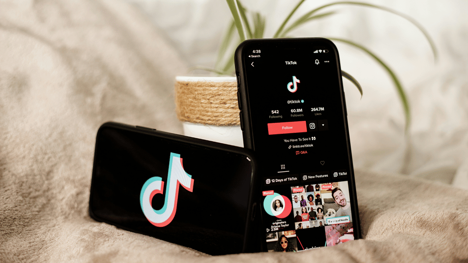  Two smartphones sit open to TikTok, while their owners discuss how to get more followers on TikTok.