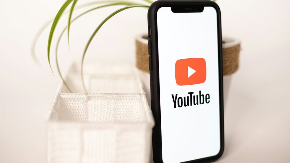  A smartphone loads the YouTube app, getting ready to select royalty free music for YouTube live streams.