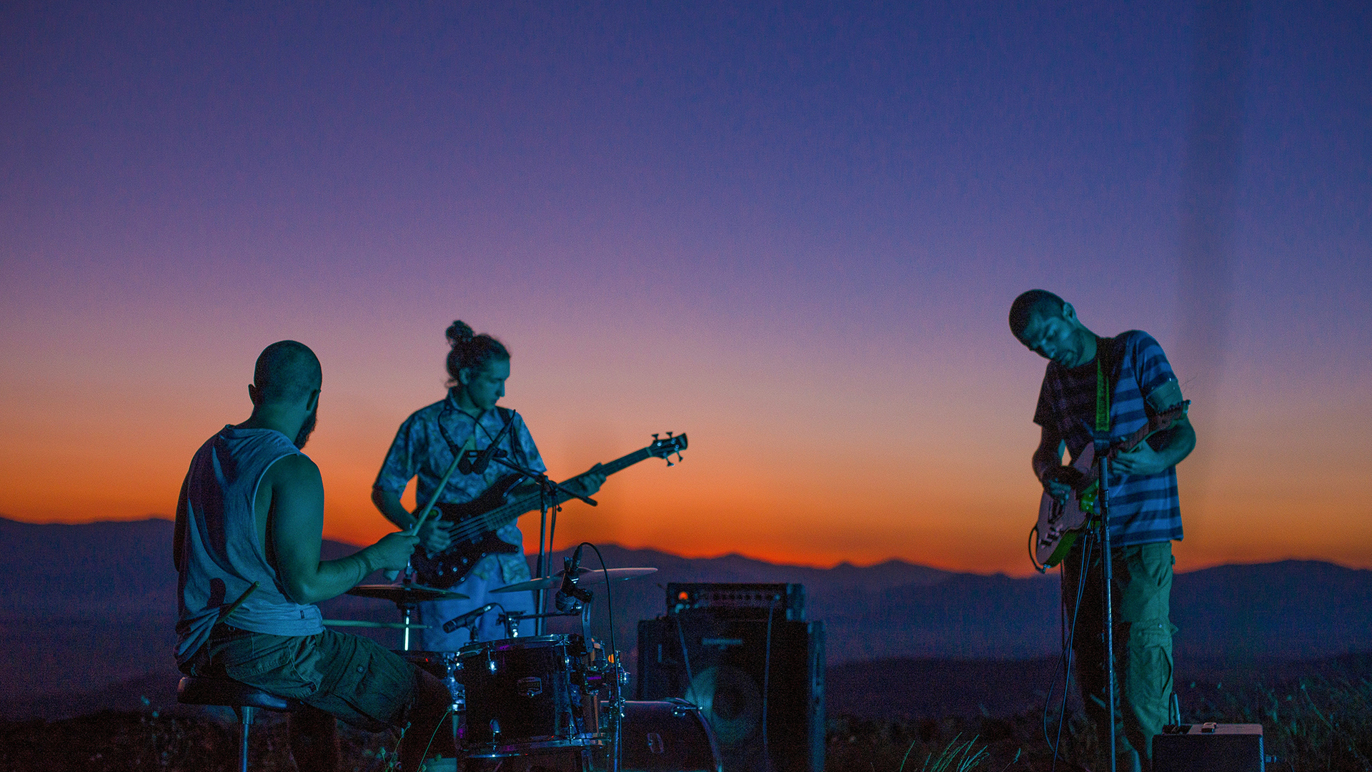 Group of musicians creating copyrighted music outside at sunset