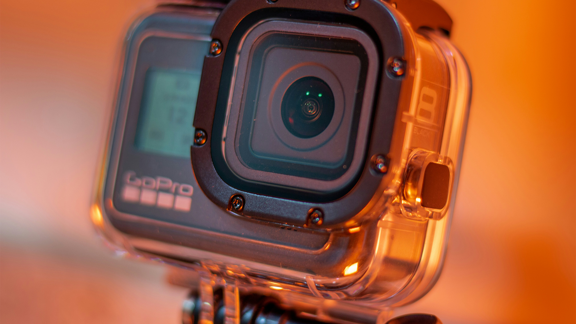 A GoPro camera inside protective housing captures a beautiful scene while a content creator learns how to use the GoPro Quik app