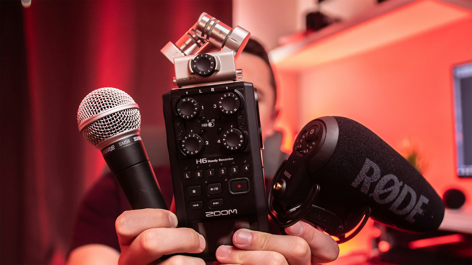 A creator holds up three different sound recording devices, capable of capturing room ambient sound to be used for room tone downloads.